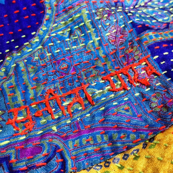 Artisan signature on silk kantha scarf